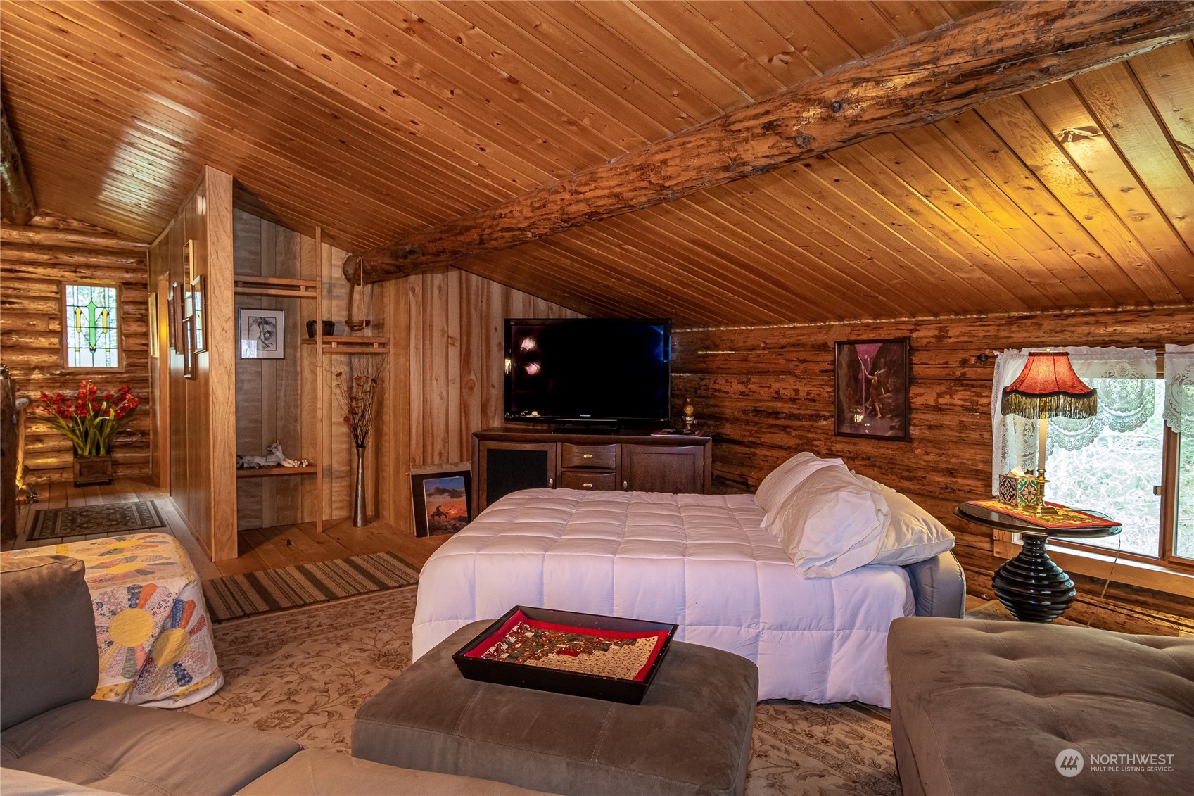 8526 Davenport Road Anderson Island, WA 98303 - Photo 23 of 31 a bedroom with furniture and a flat screen tv