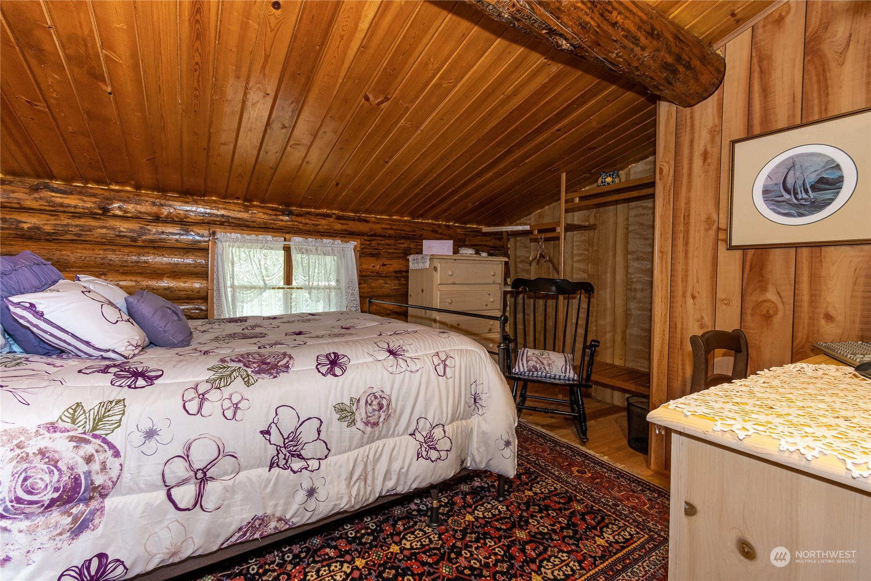 8526 Davenport Road Anderson Island, WA 98303 - Photo 24 of 31 a bedroom with a bed and a table
