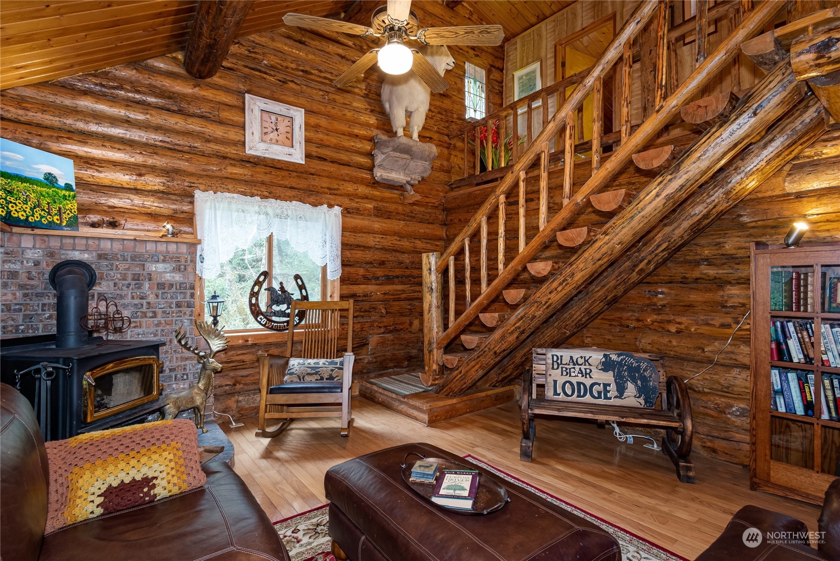 8526 Davenport Road Anderson Island, WA 98303 - Photo 4 of 31 a living room with furniture a piano and a fireplace