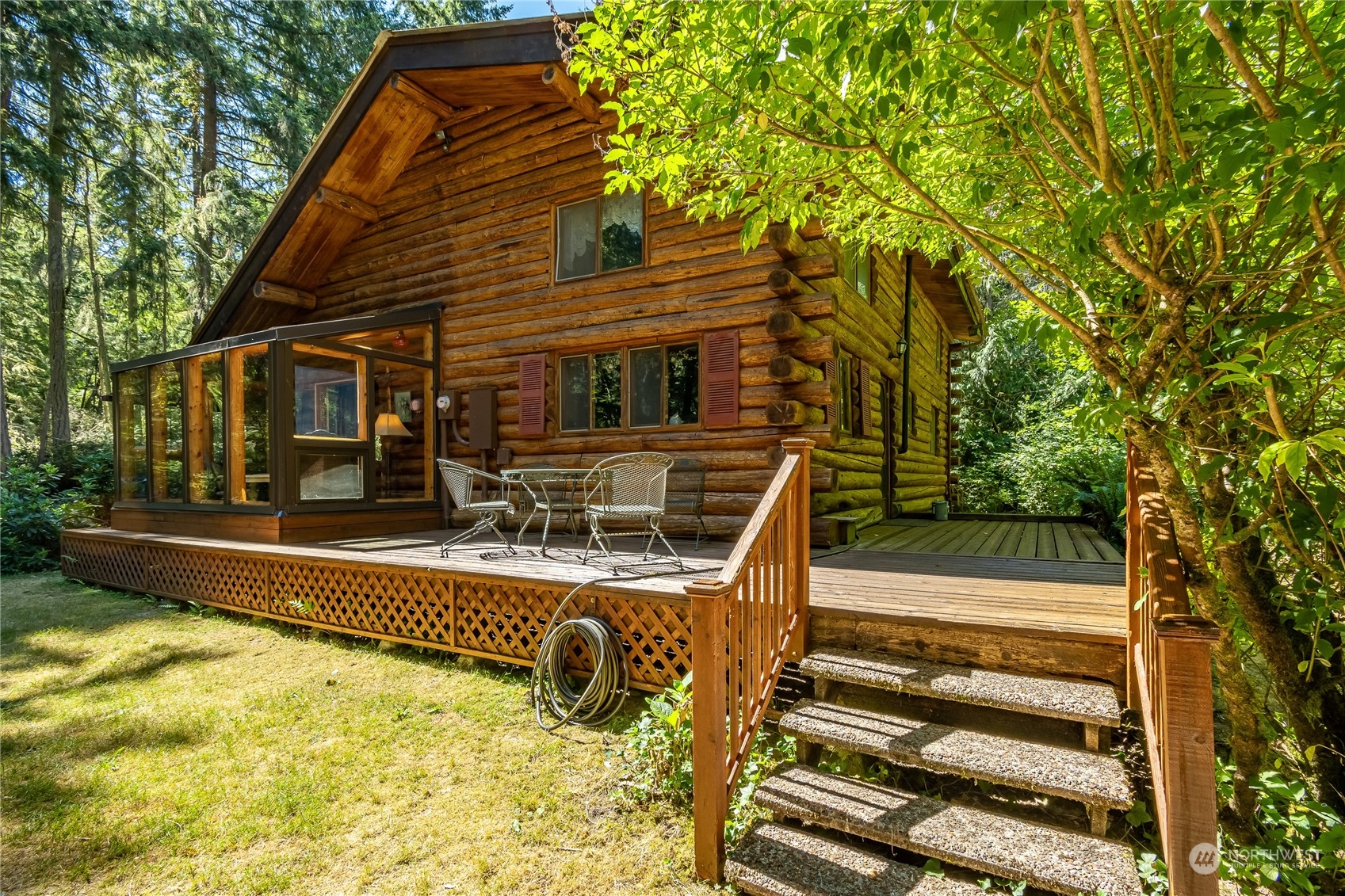 8526 Davenport Road Anderson Island, WA 98303 - Photo 5 of 31 a view of a house with pool and chairs