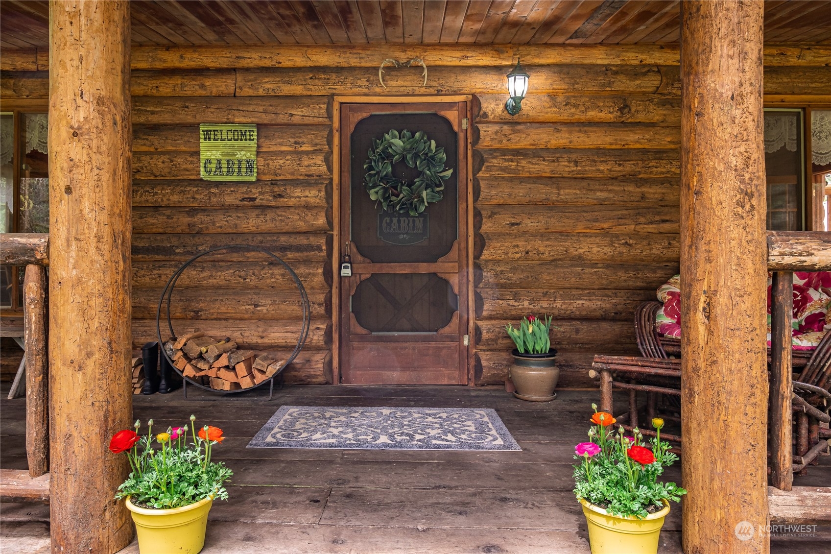 8526 Davenport Road Anderson Island, WA 98303 - Photo 6 of 31 a front view of a house with lots of flowers