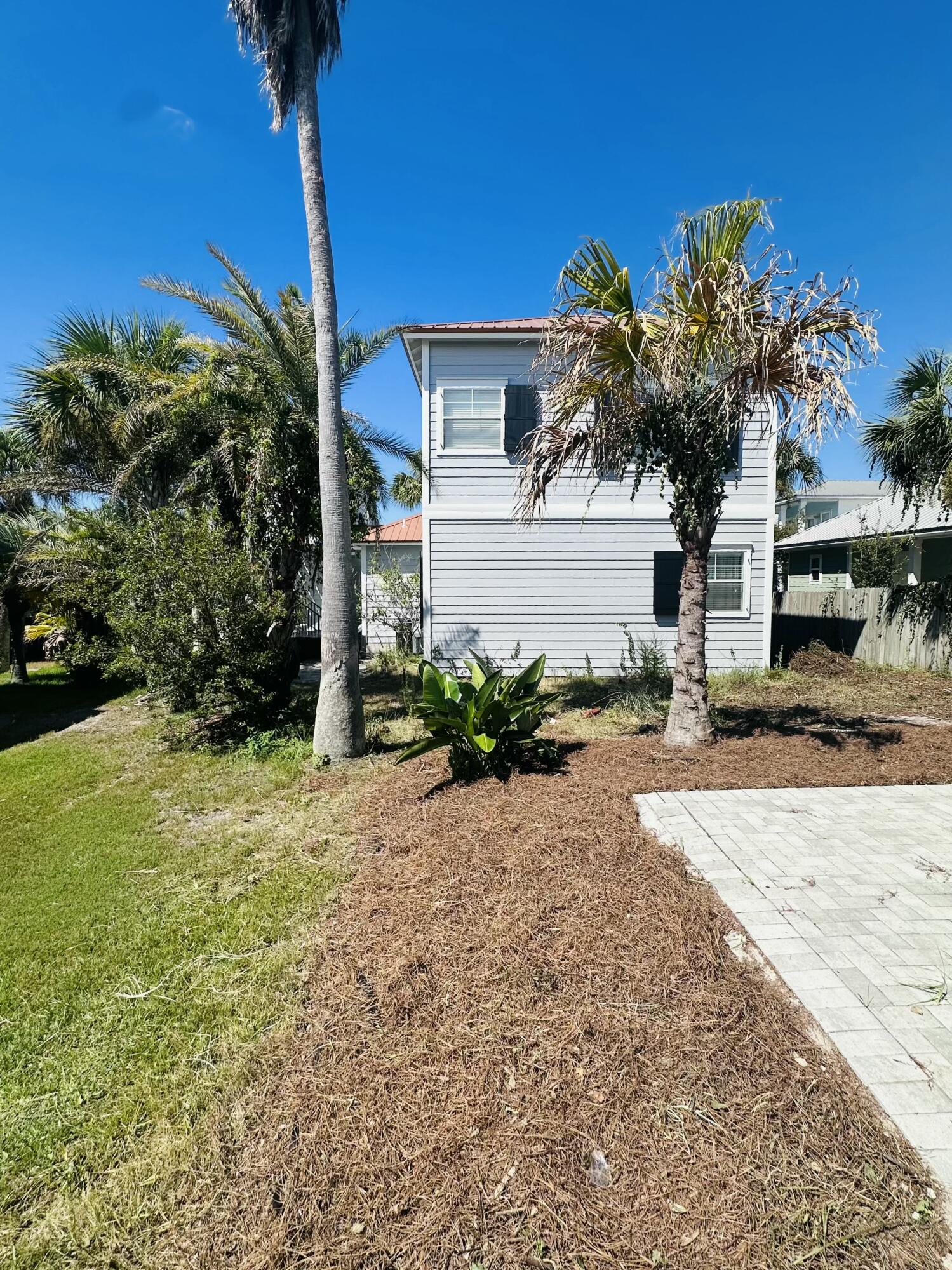 41 Abbie Road Santa Rosa Beach, FL 32459 - Photo 31 of 38 a front view of a house with a yard and potted plants