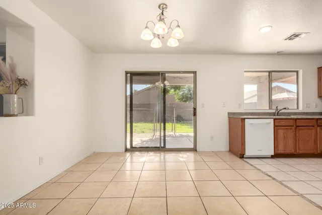 a view of a livingroom with wooden floor and a ceiling fan