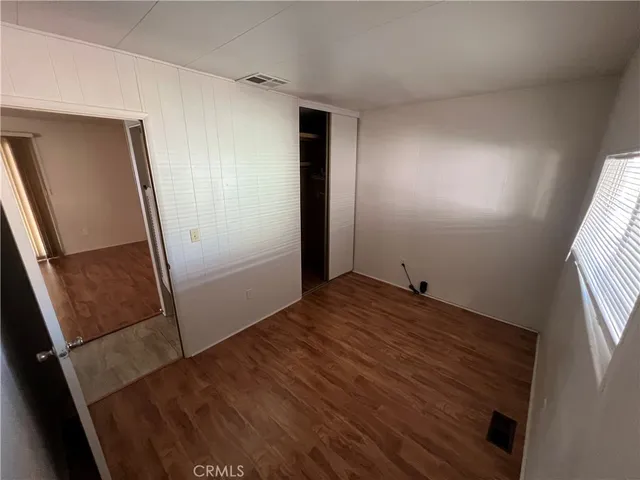 an empty room with wooden floor