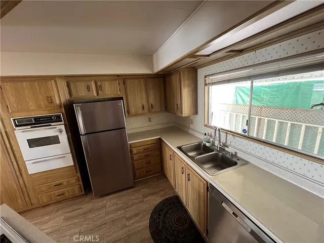 a kitchen with a refrigerator and a sink