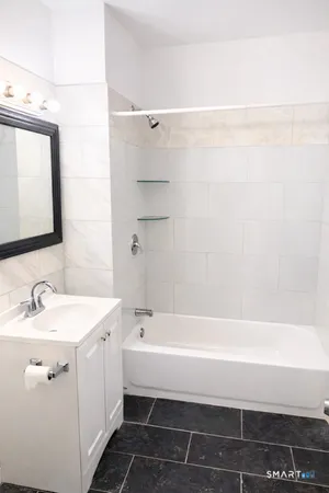 a bathroom with a bathtub and a sink