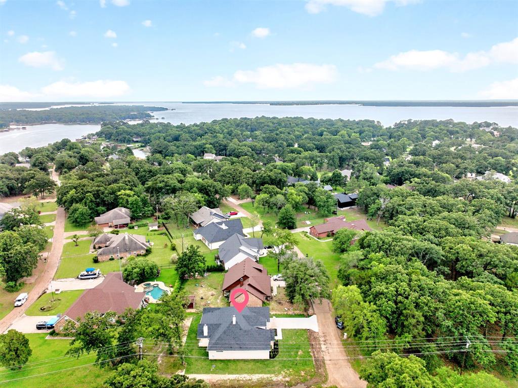 120 Springwood Road Enchanted Oaks, TX 75156 - Photo 36 of 37 Aerial perspective showcasing a residential area with a prominent body of water in the background