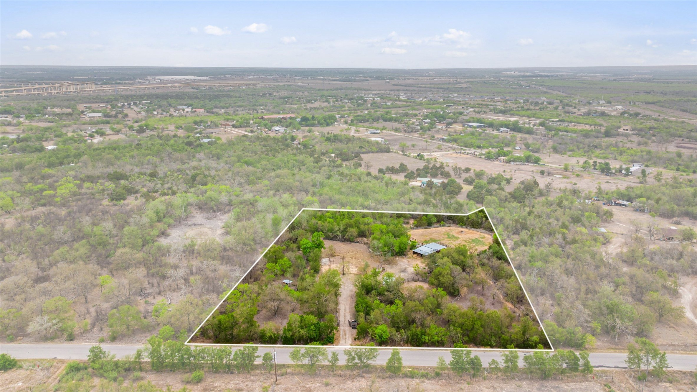 Surrounded by oaks, this nearly 3-acre private and serene lot offers a head start with existing improvements, ready for you to bring your vision to life.