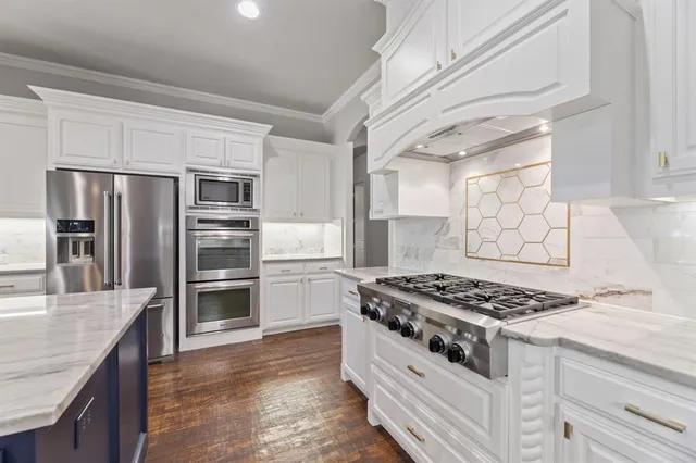 a kitchen with granite countertop a stove and a refrigerator