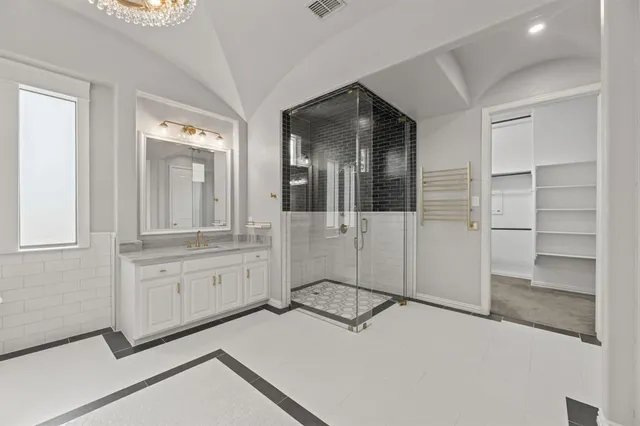 a spacious bathroom with a shower and a sink