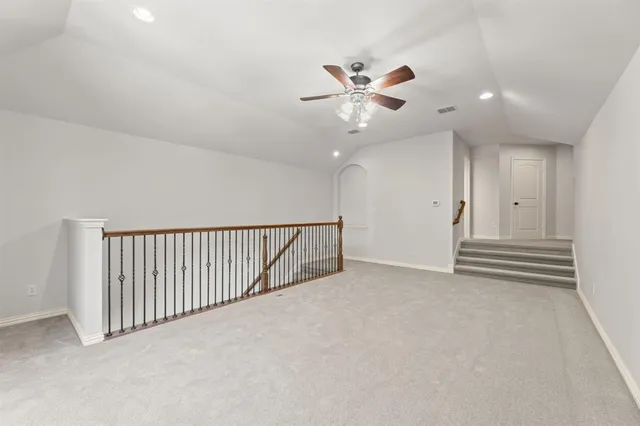 a view of a hallway with a ceiling fan