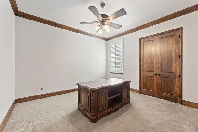 a room with bed and ceiling fan