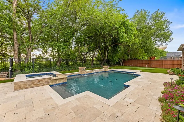 a view of a swimming pool with a yard