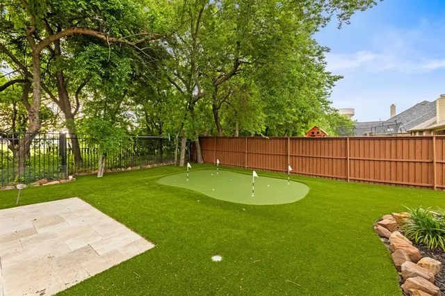 a view of a backyard with wooden fence