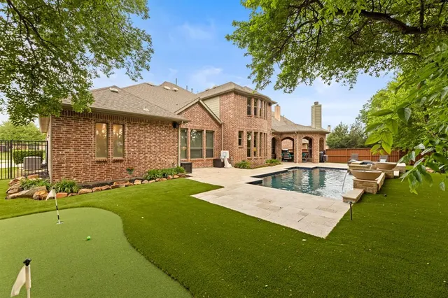 a view of house that has a yard