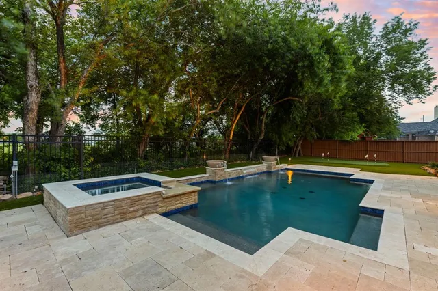 a view of a swimming pool with a yard