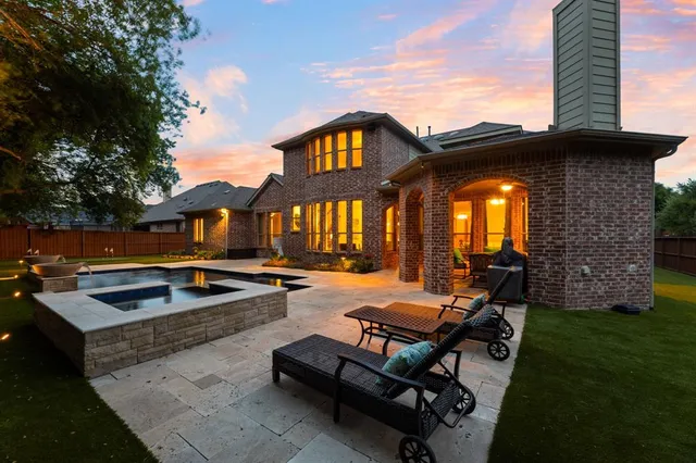 a view of swimming pool with lounge chair and dinning table under an umbrella
