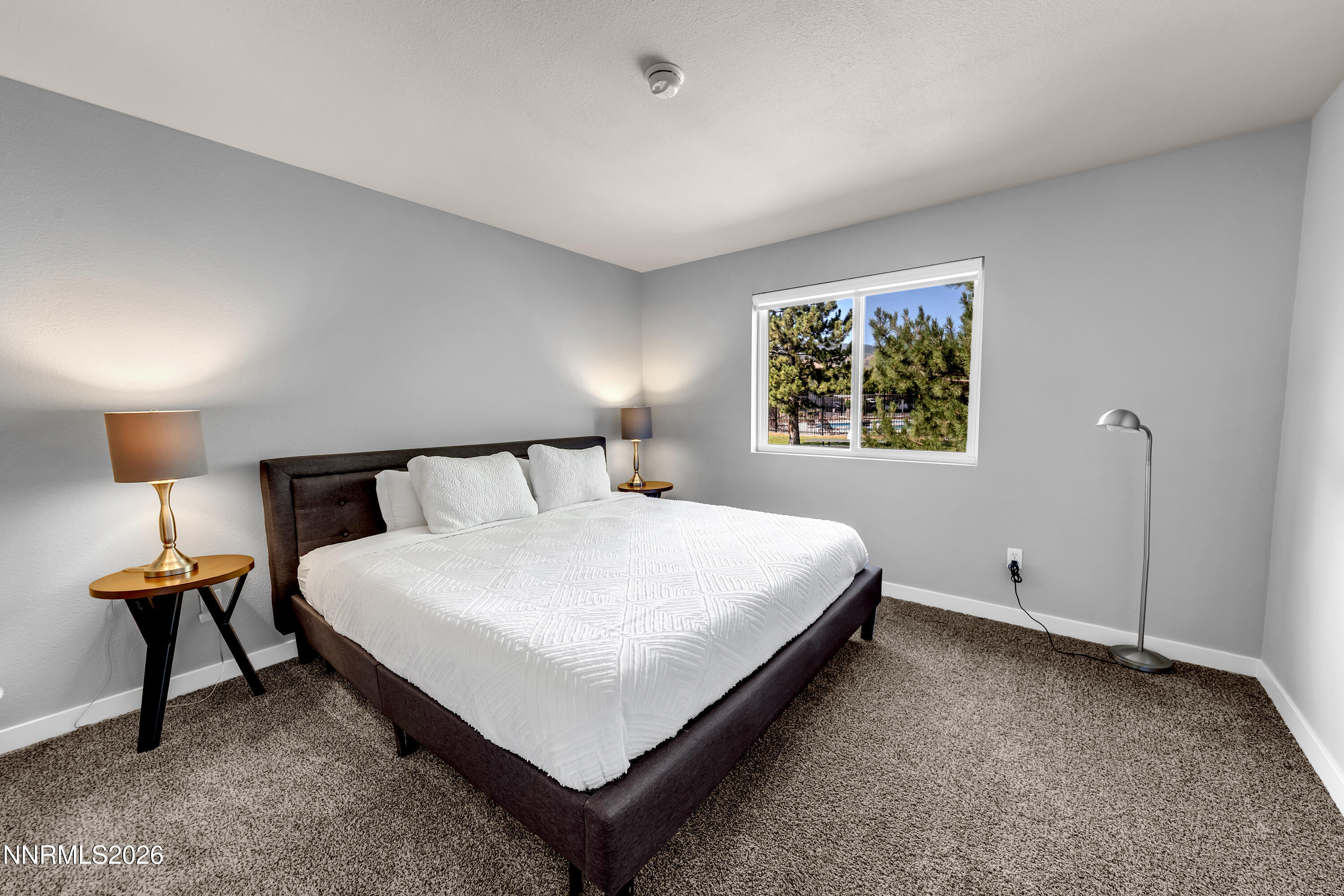 6850 Sharlands Avenue, Unit E 2022 Reno, NV 89523 - Photo 6 of 19 a bedroom with a bed and window