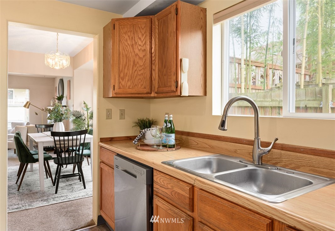 1809 North 41st Street Seattle, WA 98103 - Photo 12 of 32 a kitchen with a sink a counter and a dining table