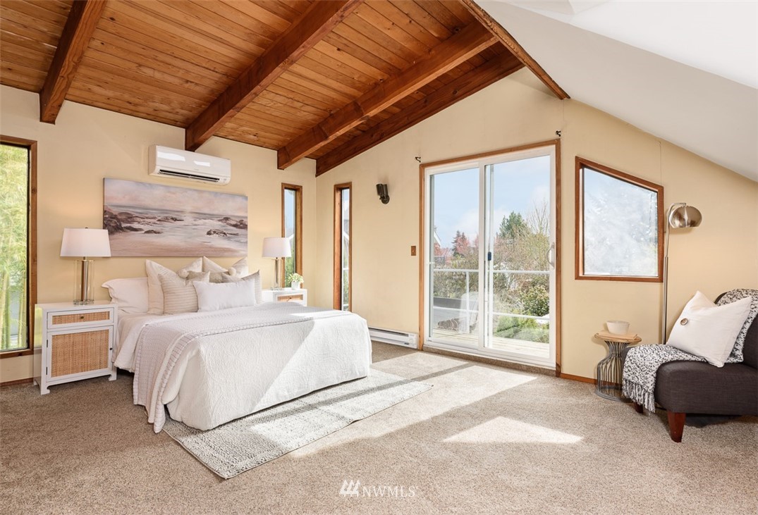 1809 North 41st Street Seattle, WA 98103 - Photo 14 of 32 a spacious bedroom with a bed couch and a large window
