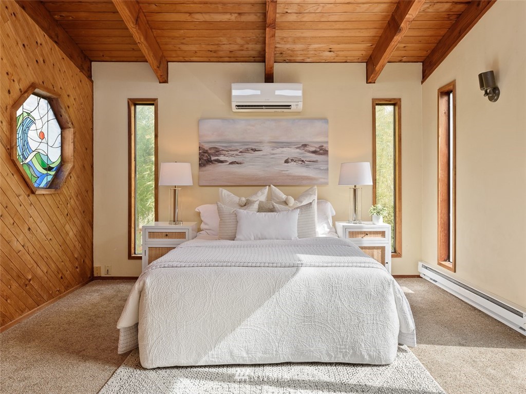 1809 North 41st Street Seattle, WA 98103 - Photo 15 of 32 a bedroom with a bed a dresser next to a window
