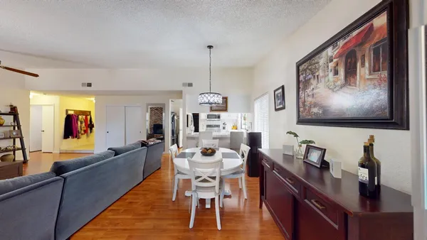 a living room with stainless steel appliances furniture and a window