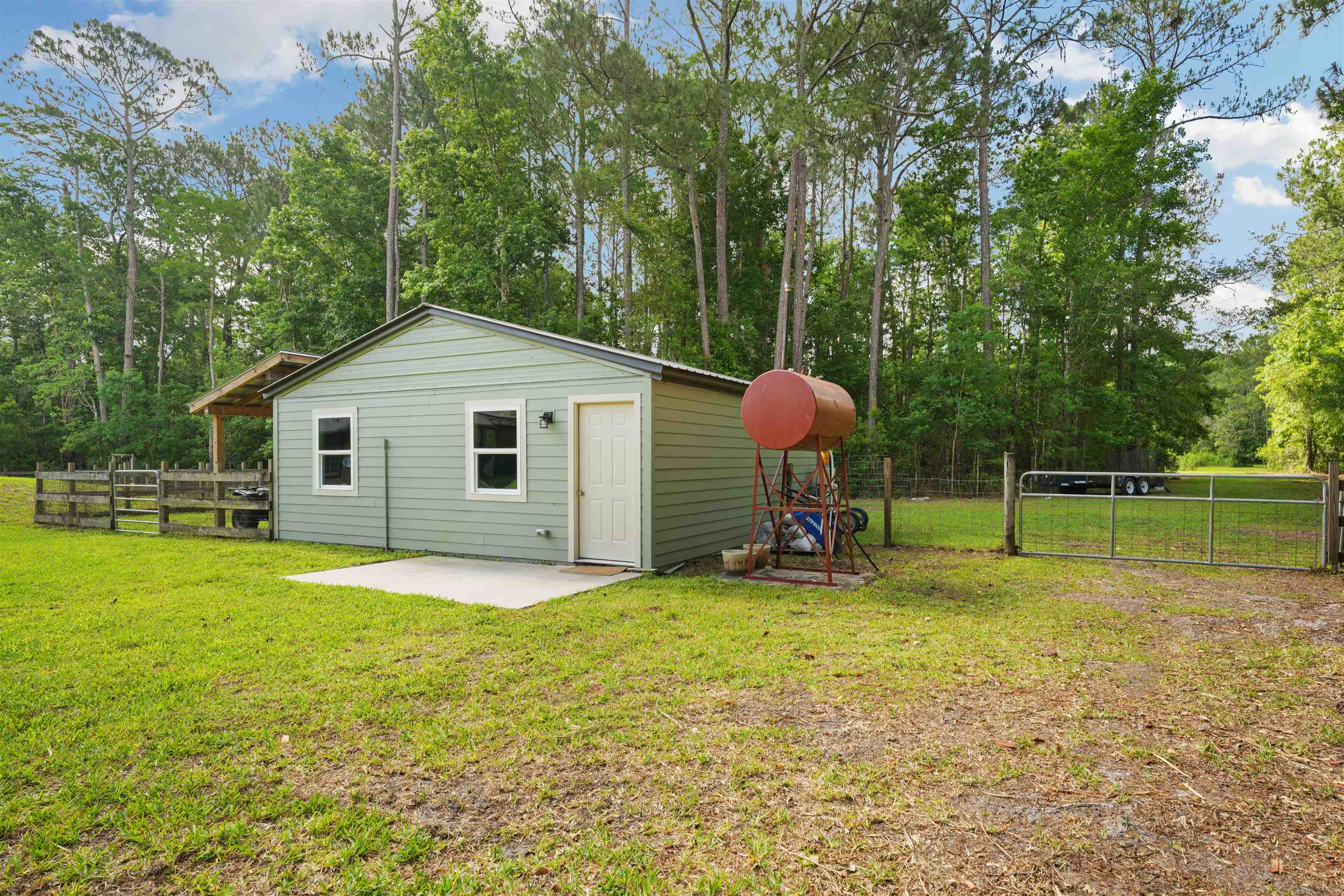 1805 Bennett Road St. Augustine, FL 32092 - Photo 45 of 65 a view of a house with a backyard and trees
