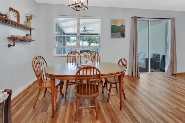 a view of a dining room with furniture window and wooden floor