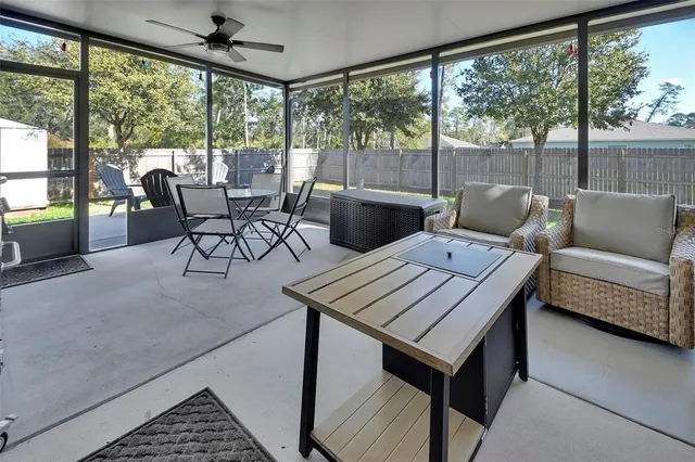 a living room with furniture and a floor to ceiling window