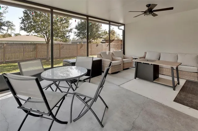 a dining room with furniture and a large window