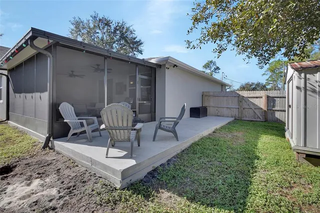 a view of a chairs and table in backyard
