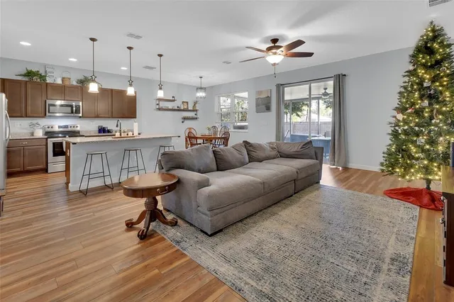 a living room with furniture and a chandelier