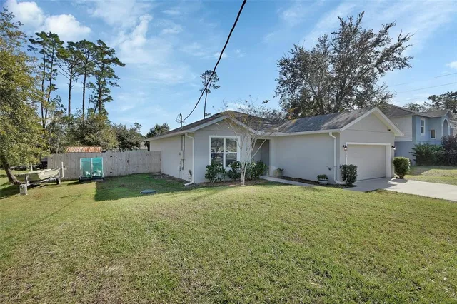 a view of a house with a yard and garage