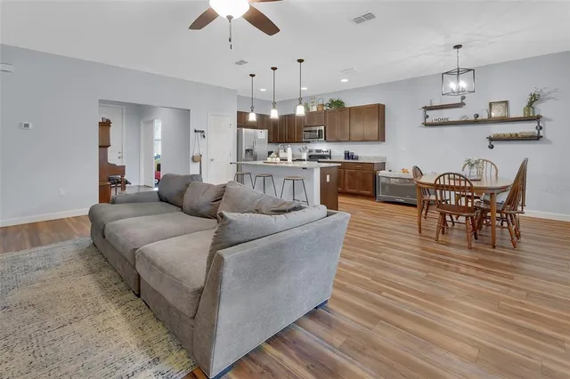 a living room with furniture and kitchen view