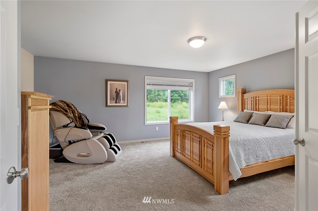 1311 190th Street Southeast Bothell, WA 98012 - Photo 22 of 39 a bedroom with a bed and a table in it