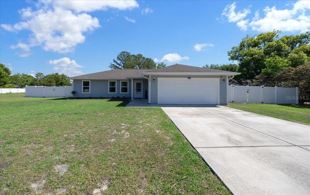 13 Teak Loop Place Ocala, FL 34472 - Photo 1 of 36 a view of a house with a yard and potted plants