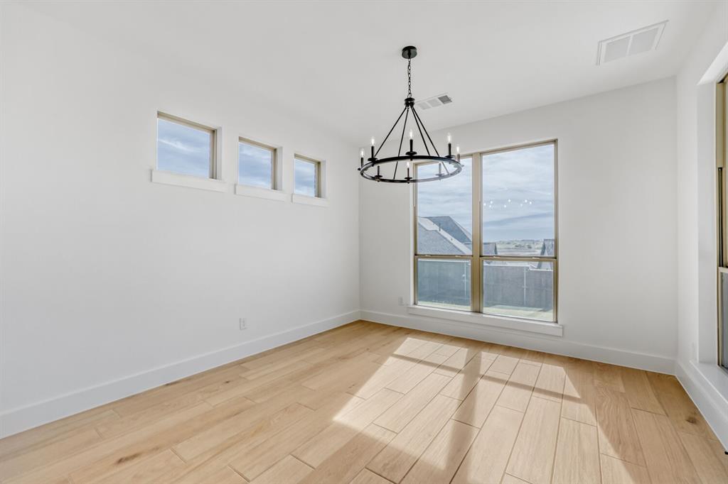147 Derrett Lane Rhome, TX 76078 - Photo 2 of 28 Unfurnished dining area with light wood-style flooring and hanging lights