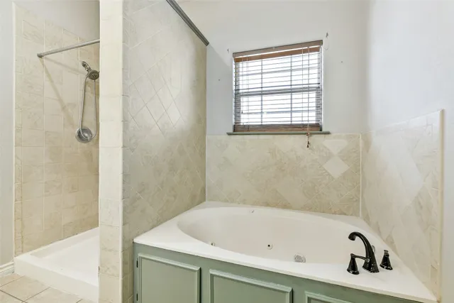 a view of an empty room with a chandelier fan