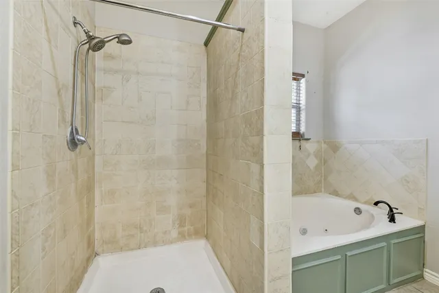 an empty room with chandelier fan and windows