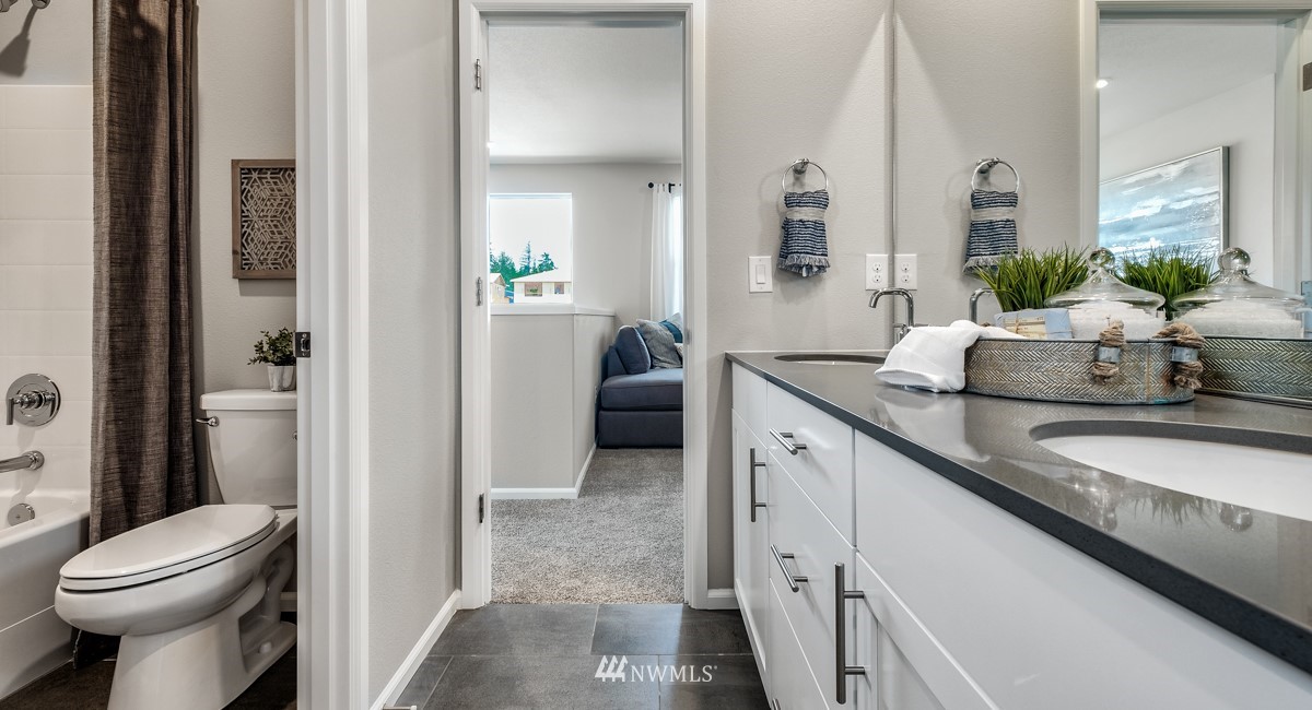 23435 41st Drive Southeast, Unit 33 Bothell, WA 98021 - Photo 15 of 24 a spacious bathroom with a granite countertop sink and a mirror
