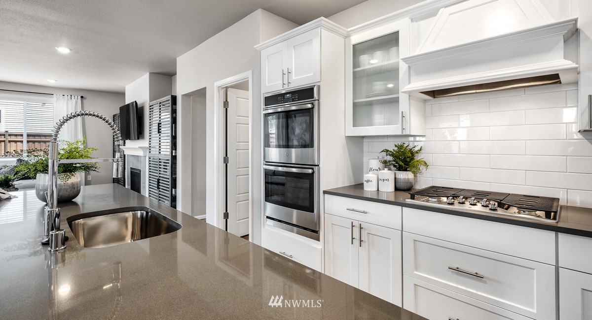 23435 41st Drive Southeast, Unit 33 Bothell, WA 98021 - Photo 9 of 24 a kitchen with granite countertop a sink stainless steel appliances and cabinets