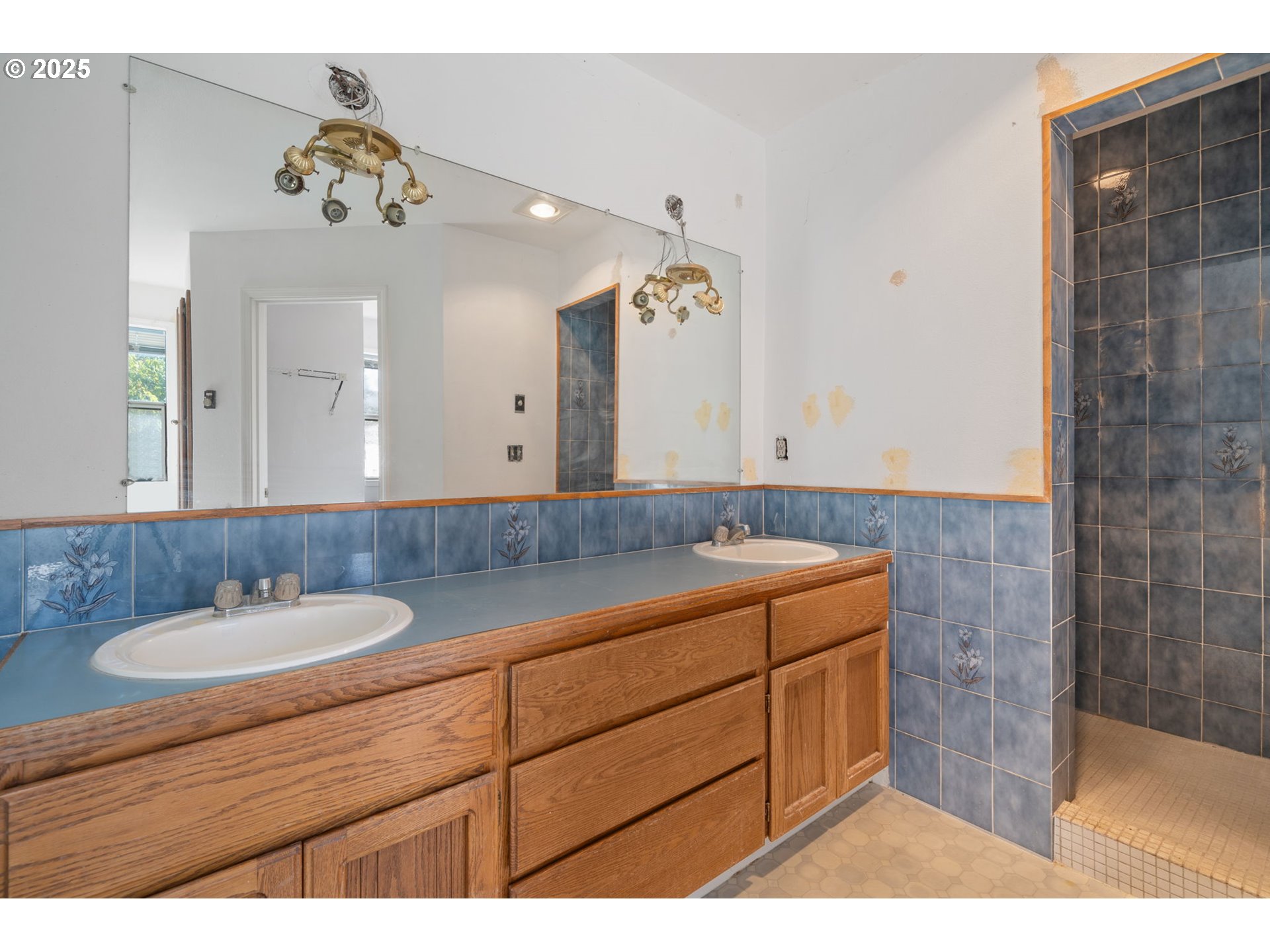 3411 Northeast 179th Street Ridgefield, WA 98642 - Photo 33 of 48 a bathroom with a sink double vanity granite and a mirror
