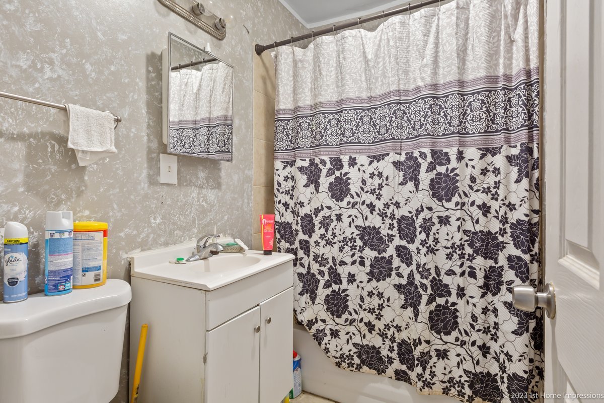 8807 South Lowe Avenue Chicago, IL 60620 - Photo 12 of 19 a bathroom with a sink and a shower curtain