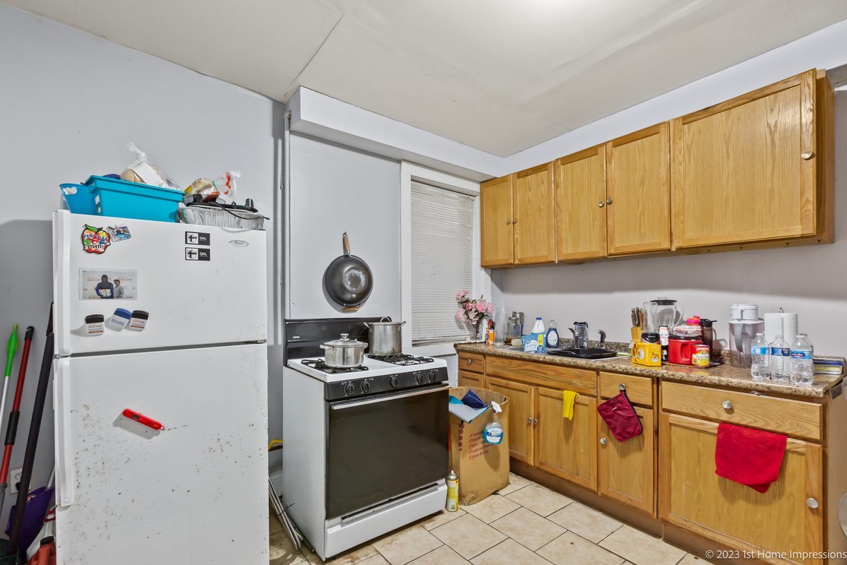 8807 South Lowe Avenue Chicago, IL 60620 - Photo 14 of 19 a kitchen with stainless steel appliances a stove a refrigerator and a sink