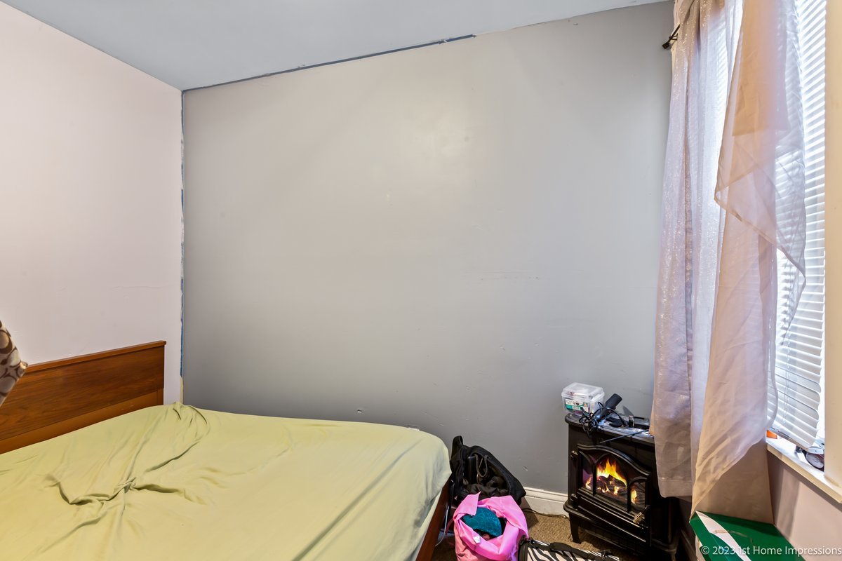 8807 South Lowe Avenue Chicago, IL 60620 - Photo 15 of 19 a bedroom with a bed and a window in it