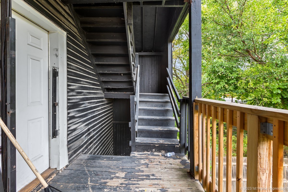 8807 South Lowe Avenue Chicago, IL 60620 - Photo 16 of 19 a view of a balcony with wooden floor and stairs