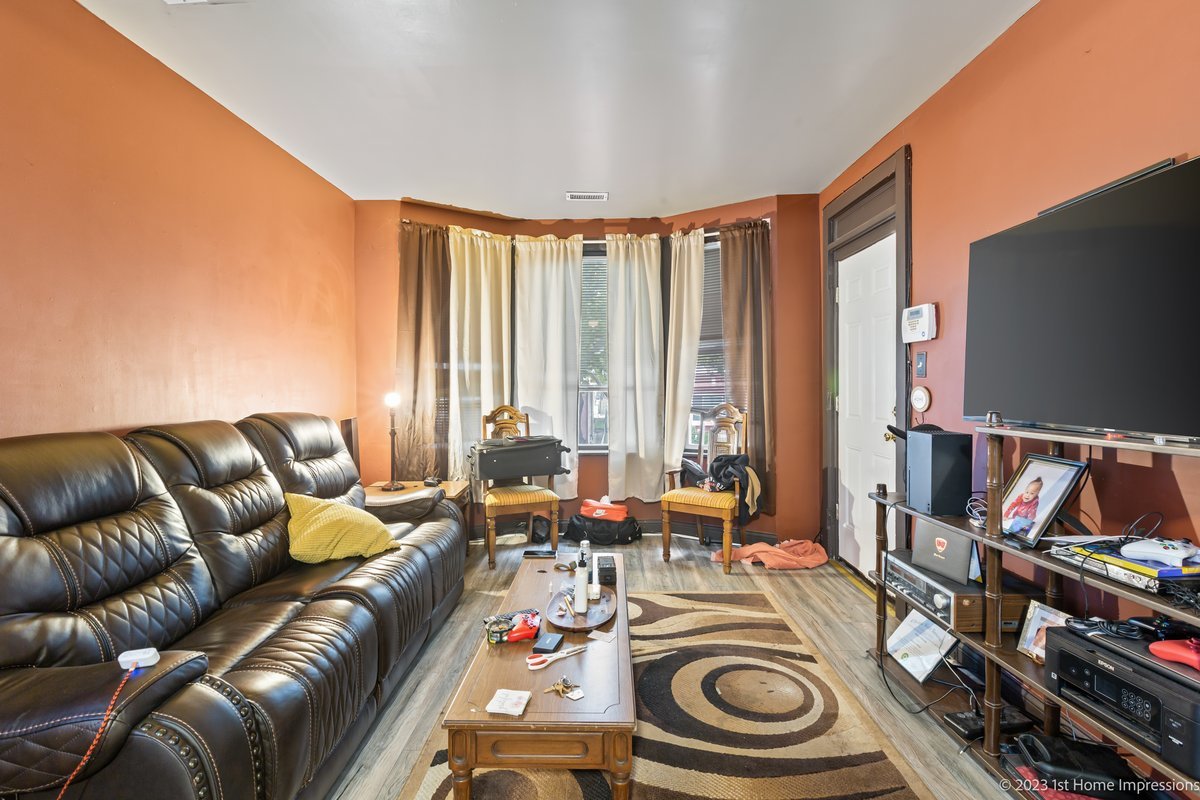 8807 South Lowe Avenue Chicago, IL 60620 - Photo 4 of 19 a living room with furniture and a flat screen tv