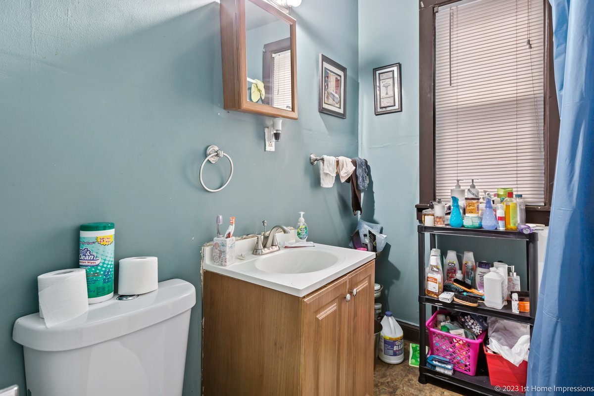 8807 South Lowe Avenue Chicago, IL 60620 - Photo 6 of 19 a bathroom with a sink toilet and a mirror