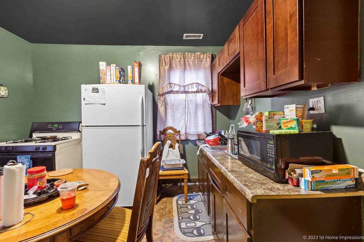 8807 South Lowe Avenue Chicago, IL 60620 - Photo 8 of 19 a kitchen with a refrigerator and a stove top oven