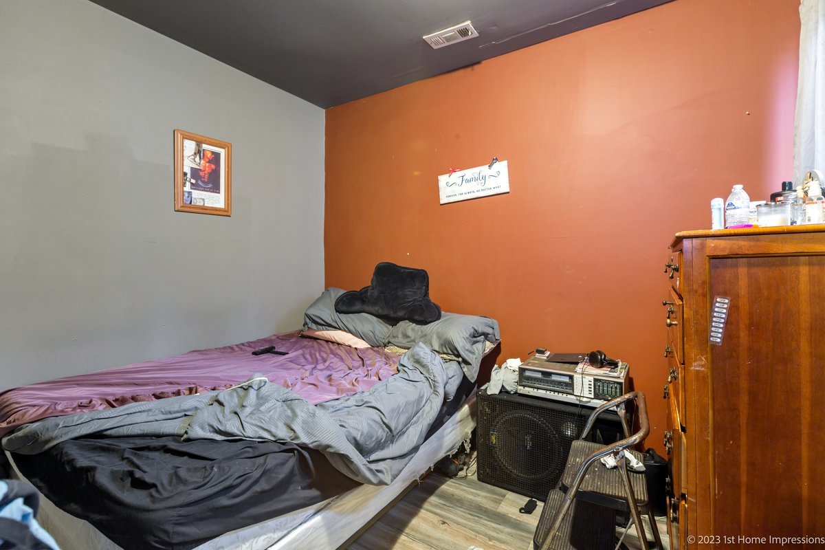 8807 South Lowe Avenue Chicago, IL 60620 - Photo 10 of 19 a bedroom with a bed and a wooden floor